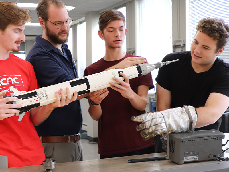 A CCAC Spaceflight Student Team from the college's Mechatronics Apprenticeship program, Digital Electronics Class. Pictured from left to right: Christopher Beaver, Peter Humphrey, Brennan Yohe, and Geordan Lubay.