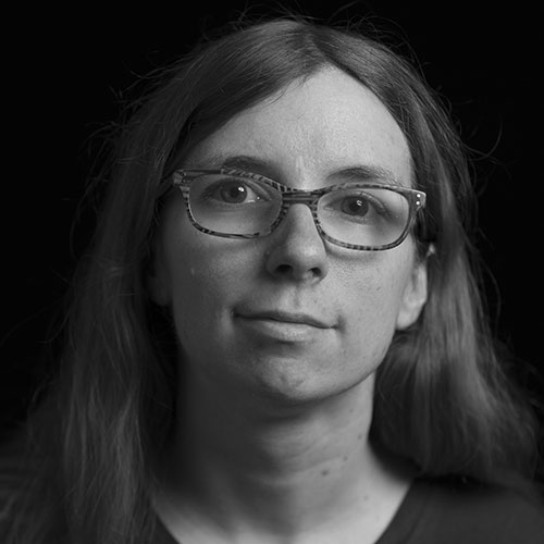 A black and white headshot of of Kelly Kolar