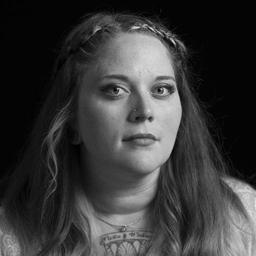 A black and white headshot of Kacey Merchant